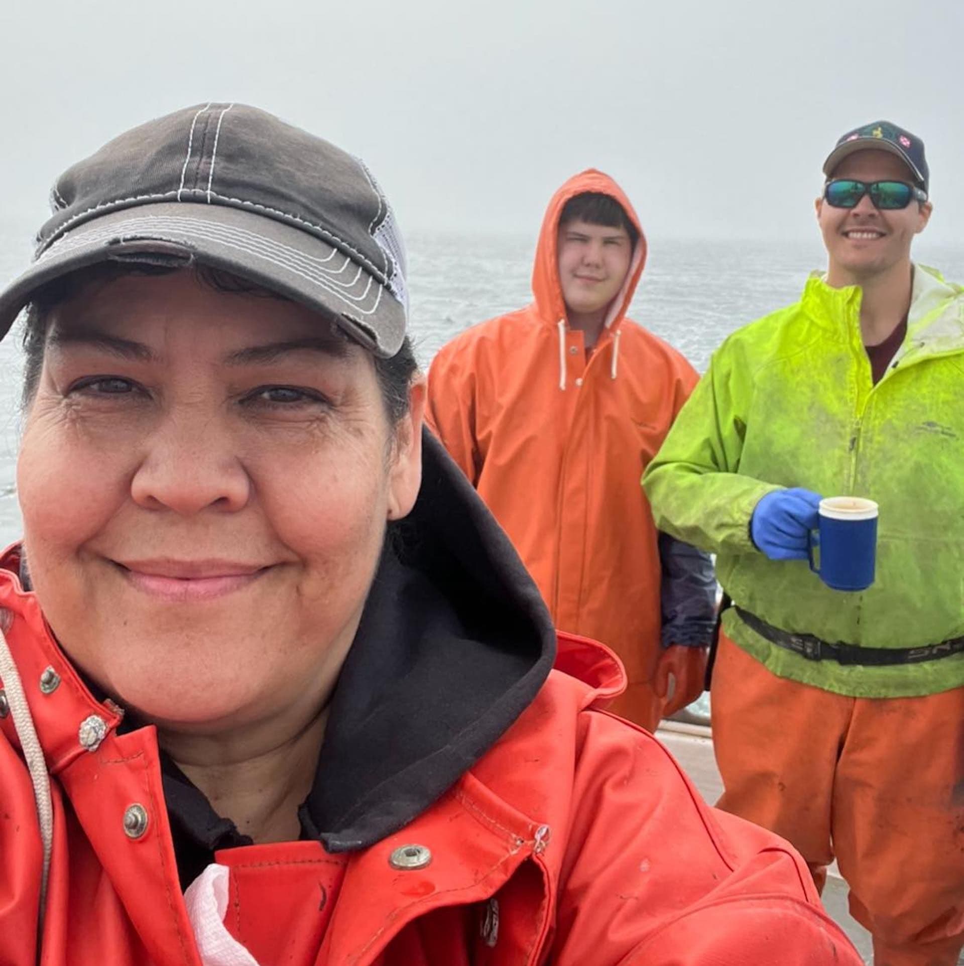 The Carpenter Family stand aboard their fishing vessel