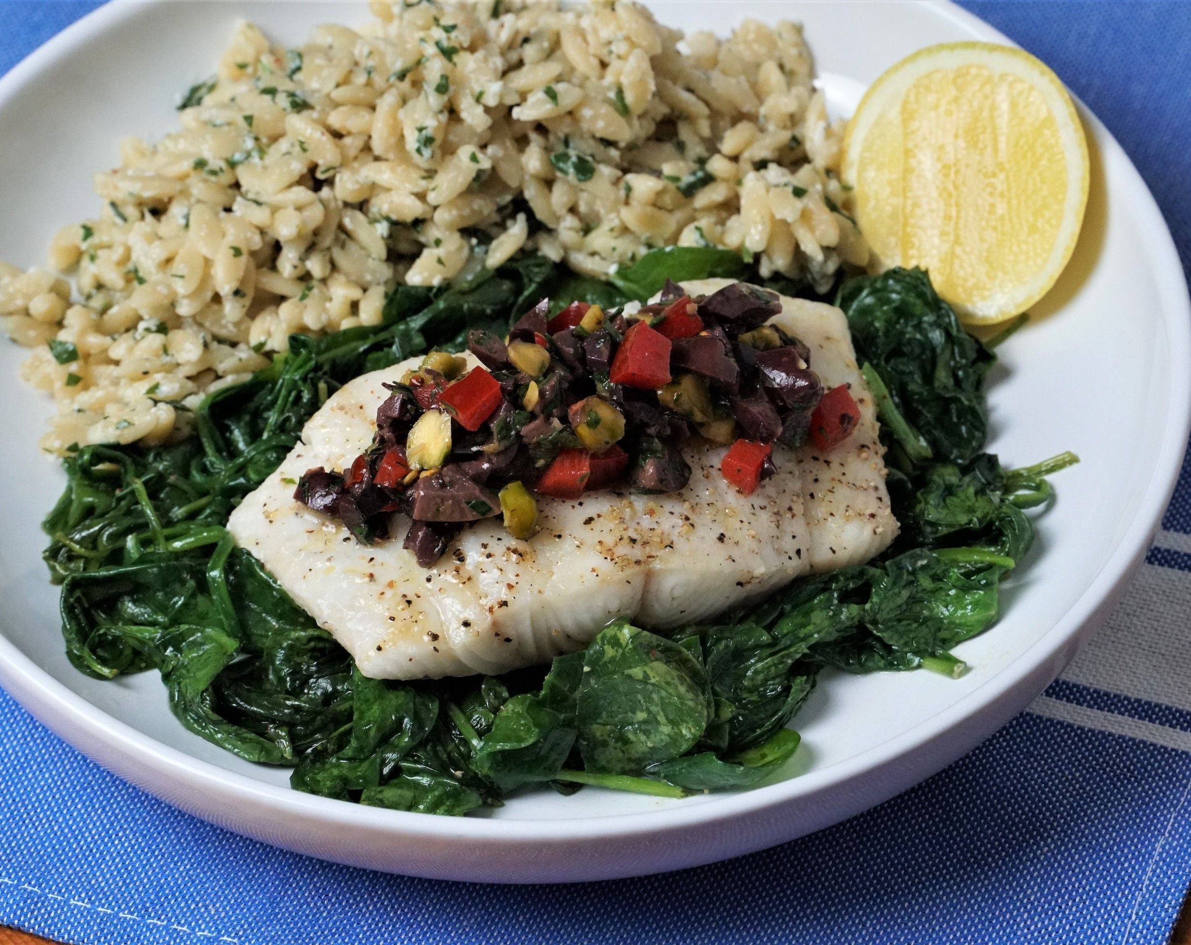 Baked White Fish with Spinach, Kalamata Gremolata, and Savory Herbed Orzo Pilaf