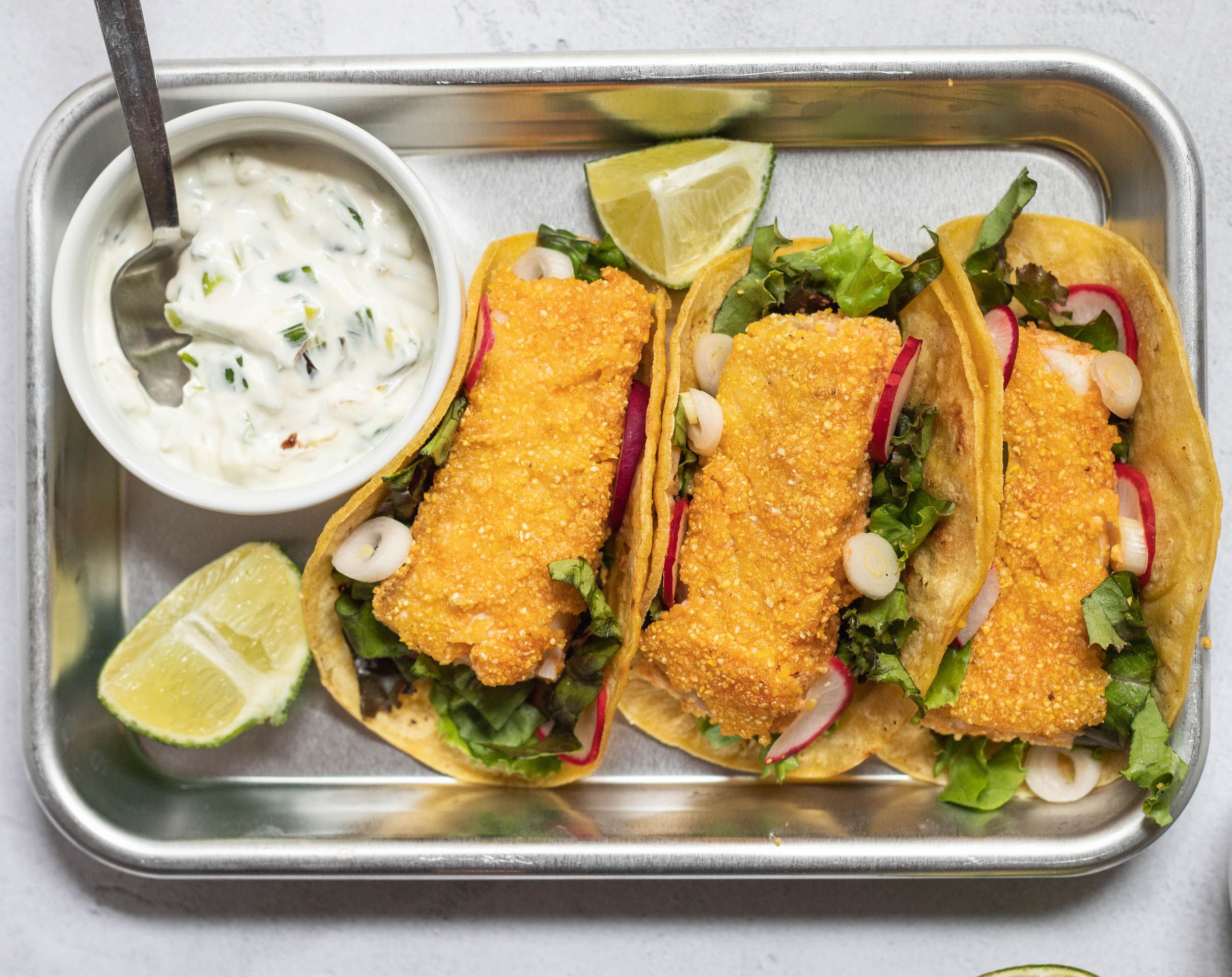 Crusted Halibut Tacos with Charred Scallion Crema and “Pickled” Onions and Radishes