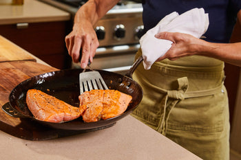 2 salmon fillets in a skillet