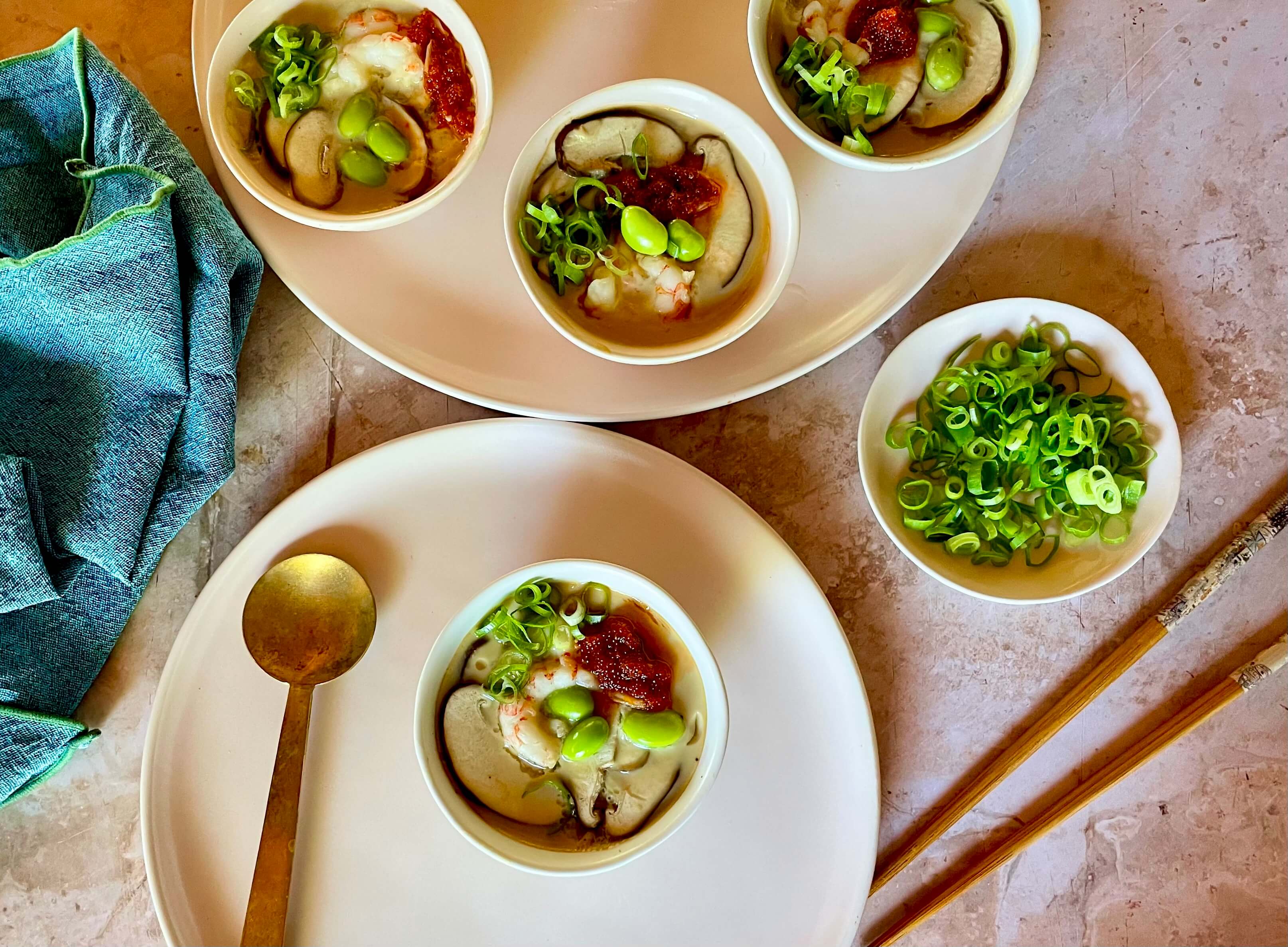 bowls on a plate with spoon and chopsticks