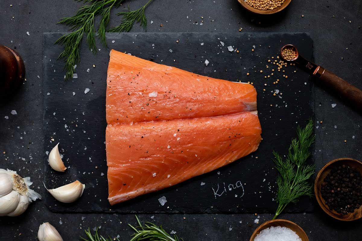 raw-king-salmon-portion-fillet-on-cutting-board.jpg